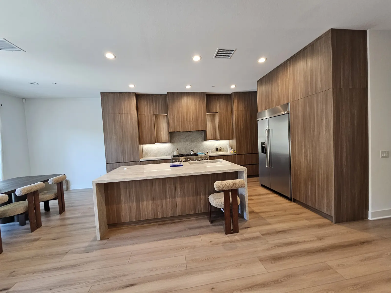 The same room with the new wood-finish kitchen installed after the removal